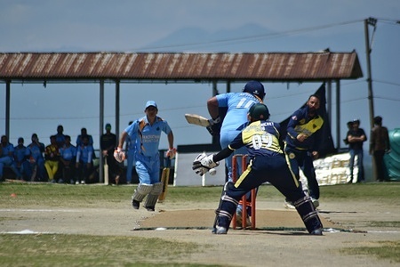 Kashmiri cricket players play cricket in a sunny day during Etihad Cricket Tournament which is held at Olympic Stadium Budgam.