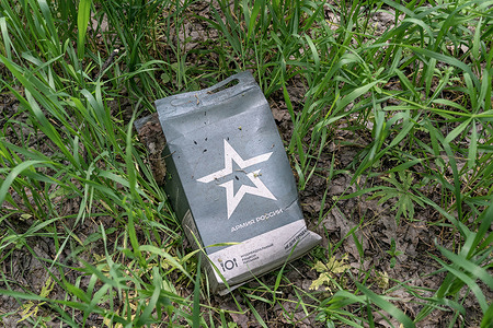 Bag from food rations left by Russian forces during occupation near village of Sulyhivka, Kharkiv region of Ukraine. Russian forces hasty retreated leaving behind ammunition, tanks, garbage, shoes, sleeping bags, and etc. Ukrainian forces on this location found almost 30 tanks in good conditions they fixed and reuse against Russian army.