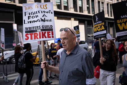 Author David Simon, a member of the Writers Guild of America and part of the guild's negotiating committee marches on a picket line in front of Netflix offices. After contract negotiations failed, thousands of unionized writers voted unanimously to strike, bringing television production to a halt, and initiating the first walkout in 15 years.