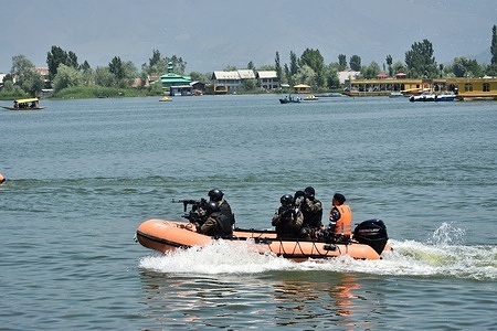 Indian paramilitary soldiers patrol the Dal Lake ahead of G20 tourism working group meeting in Srinagar, Indian controlled Kashmir, Saturday, May 20, 2023. From May 22-24 Srinagar will host a G20 meeting on tourism as part of the G20 Summit 2023. This gathering is part of a series of meetings before the G20 summit which will be held in New Delhi in September.