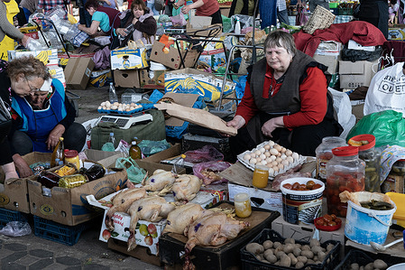 A vendor is selling eggs and chicken at the famous farmer market Pryvoz established in 1827 in Odesa. Market attracts hundreds of vendors and thousands buyers. Vendors offered dozens of kind of fresh vegetables, berries, meat, fish, dairy products, eggs, plants, flowers, as well as clothes, shoes, accessories.