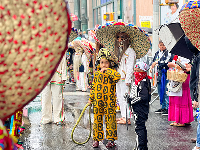 Despite the rain, participants dance their way up Sixth Avenue in New York City during the 17th Annual Dance Parade and Festival.