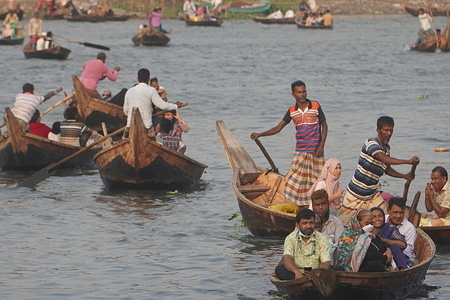 Bangladesh boatmen ferry passengers on the Buriganga river near the Kholamora ghat of the Kamrangir choir area in Dhaka. Hundreds of thousands of people cross to work every day.