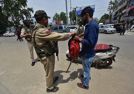 An Indian policemen checks a bag of civilian in search operation during 2nd day of 3rd G20 summit meeting in Srinagar the Summer captial of Indian Administrated Kashmir on May 23, 2023. The G20 meeting takes place in Srinagar between May 22-24, being the first major event held in the region since August 5, 2019, when the Indian government abrogated the Article 370 of the Indian constitution ending the region's semi-autonomous status and divided Jammu and Kashmir into centrally-ruled union territories of J&K and Ladakh.