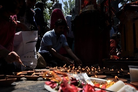 Kashmiri Hindu devotees, locally known as Pandits lights earthen lamps during the annual festival at the Kheer Bhawani Hindu temple in Tulla Mulla, 28 kilometers (17 miles) northeast of Srinagar, Indian controlled Kashmir, Sunday, May 28, 2023. Hundreds of Hindu devotees attended the prayers in the historic Kheer Bhavani Temple during the annual festival dedicated to Hindu goddess Durga.