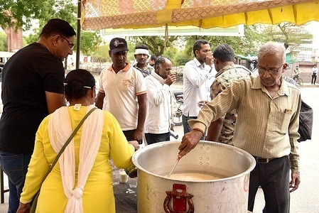 Devotees distribute buttermilk to the commuters on the occasion of Nirjala Ekadashi in Bikaner.