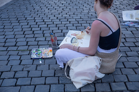 Girl paints in St. Peter's Square in Rome