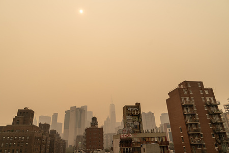 View of hazy New York city skylines during bad air quality because smoke of Canadian wildfires brought in by wind. Authorities urge people to wear masks, all outdoor activities for school children were canceled as well as regular baseball game at Yankee stadium between Yankees and White Sox. Many activities in city parks were canceled as well.