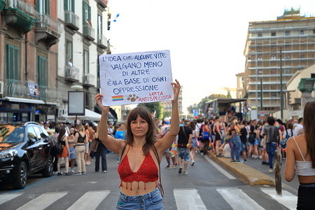 Naples ,Italy - July 01 , 2023: Seen people participate with signs and flags at the parade for the Naples Pride 2023 . Thousands of people demonstrated to demand the freedom to love without being prejudiced. A long procession marched from Piazza Dante to Rotonda Diaz on the seafront of Naples on 01 July 2023.