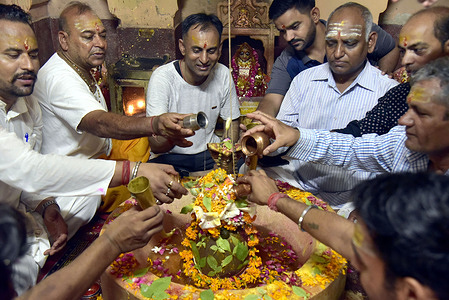 Hindu devotees perform Sahastra Ghat Abhishek rituals while offering prayers to Lord Shiva Marunayak Ji Garden on the occasion of the 'Shravan' month at Mahadev Shiv Temple in Bikaner.
