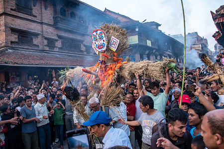 Nepalese devotees carrying straw effigy of the demon Ghantakarna during the Gathemangal festival celebrated at Bhaktapur, Nepal.