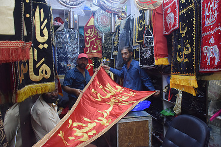 Devotees browse through religious symbols during the sacred month of Muharram, as Shiites prepare for the religious month of Muharram in Rawalpindi.