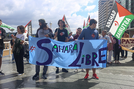 Gijon, Spain, 27th August, 2023: Three boys carry a banner calling for "Free Sahara" during the Demonstration for Peace and Justice for the Saharawi People in Gijon, Spain, on August 27, 2023.