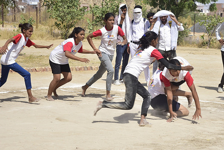 Students participate in Kabaddi competition during Rajiv Gandhi Rural and Urban Olympics 2023 at Sadul Sports School in Bikaner.