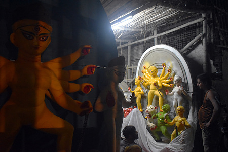 Idol makers are working inside a Pottery Hub ahead of Durga Puja festival in Kolkata.