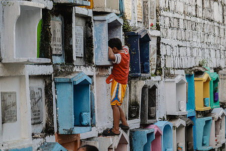 Two days before All Saint's Day, several families start arriving at Valenzuela Public Cemetery to clean and repaint the tombs of their departed loved ones.