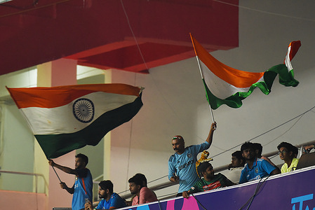 India’s cricket team supporters wave National Flags attends a practice session at the Eden Gardens Cricket Stadium in Kolkata on November 4, 2023, ahead of the 2023 ICC Men's Cricket World Cup one-day international (ODI) match between India and South Africa.