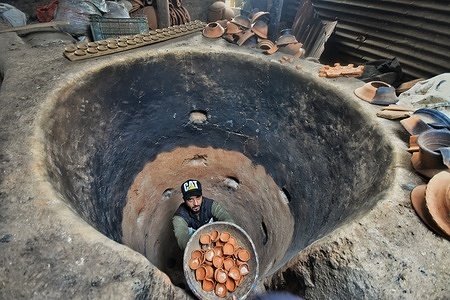 Famous potter, Muhammad Umar Kumar collect 'Diyas' or oil lamps from the kiln made from clay or mud ahead of the Diwali festival. Diwali is the Hindu festival of lights which symbolizes the spiritual ''victory of light over darkness, good over evil, and knowledge over ignorance''.