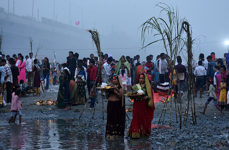 women at yamuna performing chhath puja in new delhi