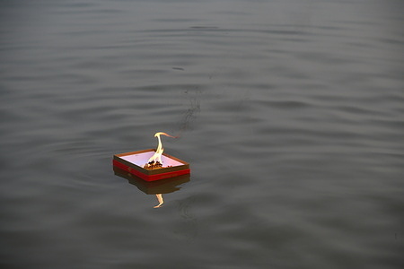 Illuminated diya floating on the Ganges at the auspicious day of Kartik Purnima signifying bhakti to Lord Vishnu by Hindu devotee (not in picture).
