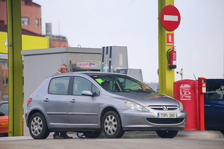 Pola de Siero, Spain, 03rd January, 2024: A vehicle being refueled during the gasoline bid farewell to 2023 marking a new annual low, on 03 January 2024, in Pola de Siero, Spain.