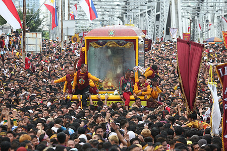 A sea of devotees herald the Andas of the Black Nazarene as it passes through Ayala Bridge. A new andas which almost fully encloses the Black Nazarene made its debut this year.