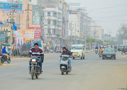 Commuters seen wearing warm clothes amid fog on a cold winter day in Beawar.