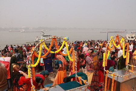 Pilgrims take a holy dip amid dense fog at the confluence of River Ganges during 'Gangasagar Mela' on the occasion of the Hindu festival of Makar Sankranti.