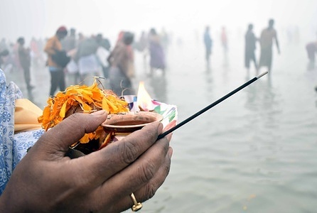 Pilgrims attend the a holy dip amid dense fog at the confluence of River Ganges and the Bay of Bengal during 'Gangasagar Mela' on the occasion of the Hindu festival of Makar Sankranti in Sagar Island, around 150 kms south of Kolkata.