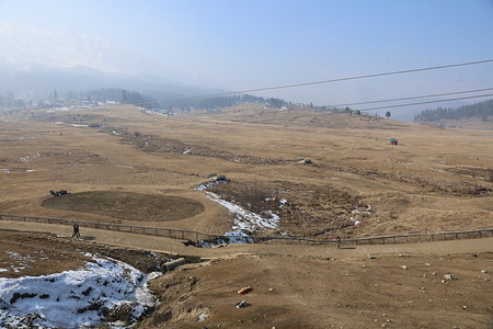 General view of dry ski slopes at the Asia top ski resort in Gulmarg, northwest of Srinagar, India-administered Kashmir. Gulmarg, a key tourist attraction in Kashmir renowned globally for its ski resorts, is experiencing an unprecedented dry spell this year, leaving its ski slopes and scenic landscapes devoid of winter snow. Both weather experts and those dependent on tourism for their livelihood are expressing concern over extended dry spell, impacting the region's economy and the expectations of winter enthusiasts. However the valley is currently experiencing an exceptional drought, with a 79% rainfall shortfall from December 2023. Experts warn that reduction in rain and snowfall might lead to water scarcity and a potential food catastrophe in the region.