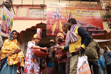 Hindu devotee wearing PM Modi and Hindu deity Lord Ram printed Panjabi distributes free fruits in front of Ram Temple ahead of the grand opening in Ayodhya of a Ram temple. The consecration ceremony on Monday will show an idol of Lord Ram placed in the temple's inner sanctum and Prime Minister Narendra Modi, alongside Hindu priests, will be in attendance.