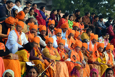 Devotees attend religious program during the 'Pran Pratishtha' ceremony Ram Mandir at Pushkarna Stadium in Bikaner.