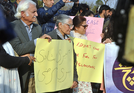 Women's rights activists hold placards as they protest against the court's verdict that declared Imran Khan's marriage to Bushra Bibi illegal under Islamic law, during a demonstration in Islamabad on February 6, 2024. A Pakistan court on February 3, 2024 ruled former prime minister Imran Khan's marriage to his third wife illegal under Islamic law and sentenced the pair to seven years each in jail, his party said.