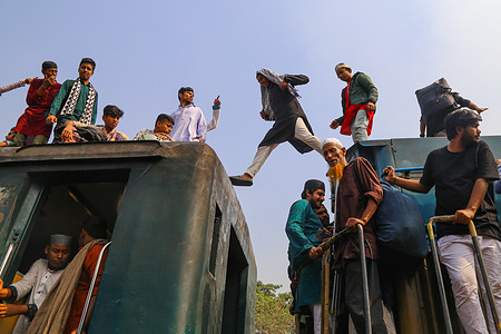 Bangladeshi Muslim devotees take risks to travel by train after attending the Akheri Munajat or final prayers, at the Biswa Ijtema, or the World Muslim Congregation, which is considered the world's second-largest Muslim gathering after Hajj. Millions of Muslim devotees from around the world join the three-day long event that ends with a special prayer on the final day, in Tongi, the outskirts of Dhaka, Bangladesh on February 11, 2024.