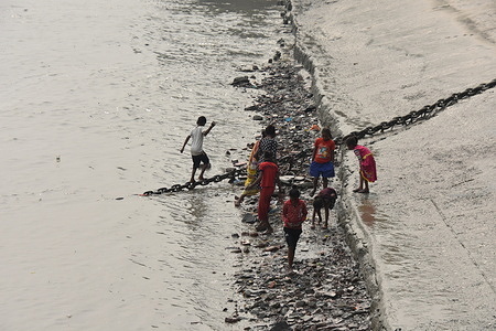 Against the backdrop of Kolkata's iconic Ghats, a community of mud larkers has made a remarkable discovery a part of their daily routine. Armed with metal detectors and sieves, these enthusiasts scour the exposed riverbed during low tide, unearthing coins, jewelry, and artifacts dating back centuries. Their finds not only serve as a testament to Kolkata's vibrant past but also contribute to the preservation of its cultural heritage. Despite facing challenges such as pollution and declining water levels, these dedicated mud larks persist in their quest for hidden treasures. Their efforts have garnered attention from locals and authorities alike, highlighting their invaluable role in uncovering the city's history. As the sun sets over the Ganges, these mud larks continue exploring, adding new chapters to Kolkata's story one discovery at a time.