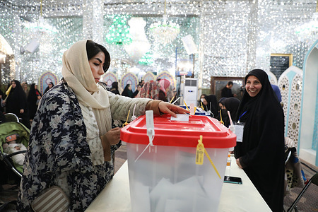 A woman casts her ballot during the parliamentary and Assembly of Experts elections at a polling station in Tehran, Iran, Friday, March 1, 2024.