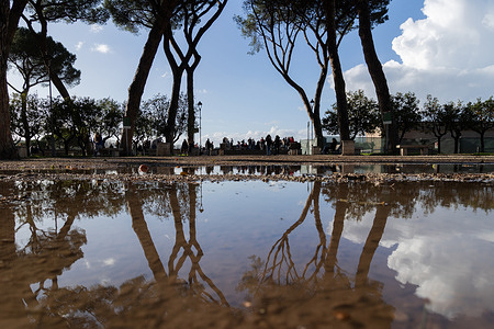 View of the Orange Garden in Rome with reflections on the puddles