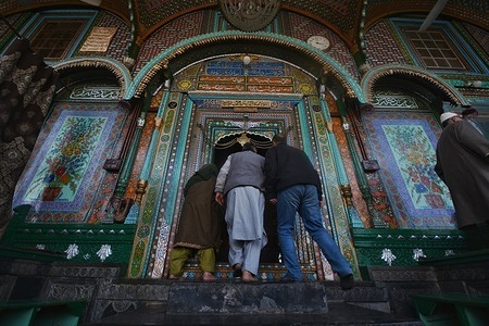 Kashmiri Muslim tached with Holy chan in side The shrine of Shah-e-Hamdan or Khanqah-e-Molla is one of the oldest Muslim Shrines in Kashmir situated on the banks of the river Jhelum in the old city during the first friday of the fasting month of Ramadan in Srinagar, the summer capital of Indian Kashmir, 15 March 2024. During Ramadan, Muslims refrain from eating, drinking and smoking from dawn to dusk.