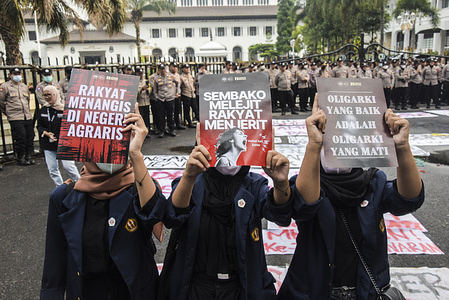 Indonesian students hold up demand posters during a demonstration in Bandung. In this action they demanded the government can stabilize prices of basic commodities and reject the politicization of social assistance