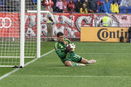 Goalkeeper Carlos dos Santos (13) of Miami makes a save during a regular MLS season game against Red Bulls on Red Bull Arena in Harrison. Red Bulls won 4 - 0. Miami was missing insured Messi. Lewis Morgan scored a hat-trick. Game was played under heavy rain.