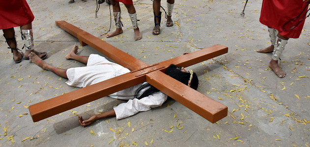 the cross lies over christ during good friday celebrations enactment at mashigarh church in new delhi