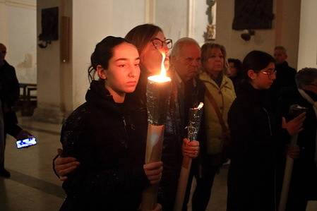 March 29,2024 ,Sessa Aurunca, Caserta ,Italy :The Archconfraternity of SS.Crocifisso and Monte dei Morti with all his confreres participated on Holy Friday in the procession of the Mysteries of the Passion and Death of Jesus through the streets of the historic center. The procession at sunset started from the Church of San Giovanni a Villa. Moments of prayer and songs accompanied the statues of the dead Christ and the mourning women throughout the evening. Along the way, large fires of bundles of branches were lit. Some women in mourning carried large lighted candles , some statues of Christ and that of the dead Christ were carried on the shoulder by men dressed in black and hooded on March 29,2024 in Sessa Aurunca, Caserta , Italy