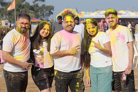 People celebrating Festivals of colors Holi at Sri Durga Mata Temple in Melbourne. Holi is a sacred ancient tradition of Hindus, a holiday in many states of India with regional holidays in other countries. It is a cultural celebration that gives Hindus and non-Hindus alike an opportunity to have fun banter with other people by throwing colored water and powder called Gulal at each other, honors the triumph of good over evil. Celebrants light bonfires, eat sweets, and dance to traditional folk music.