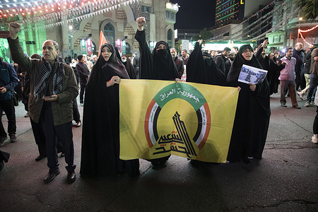 Iranian protesters hold a flag of the Iraqi Popular Mobilization Forces (PMF), known in Arabic as Hashd al-Shaabi during their anti-Israeli gathering to condemn killing members of the Iranian Revolutionary Guard in Syria, at the Palestine Sq. in downtown Tehran. An Israeli airstrike that demolished Iran's consulate in Syria killed two Iranian generals and five officers, Syrian and Iranian officials said Monday.