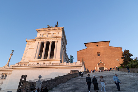 Tourists on Ara Coeli steps at sunset in Rome
