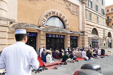 Muslims celebrate the end of Ramadan on the sidewalk of Via Andrea Doria in the Prati district of Rome