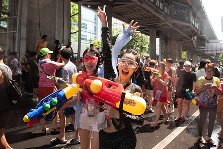 Thai and foreign tourists celebrate the event Songkran Festival, which take place on April 13, 2024. transforming Silom Road, a busy traffic route in Bangkok. Let people have fun using water to fight on this street. The Traditional Thai New Year festival “Songkran in Thailand” UNESCO inscribed on the Representative List of the Intangible Cultural Heritage of Humanity.